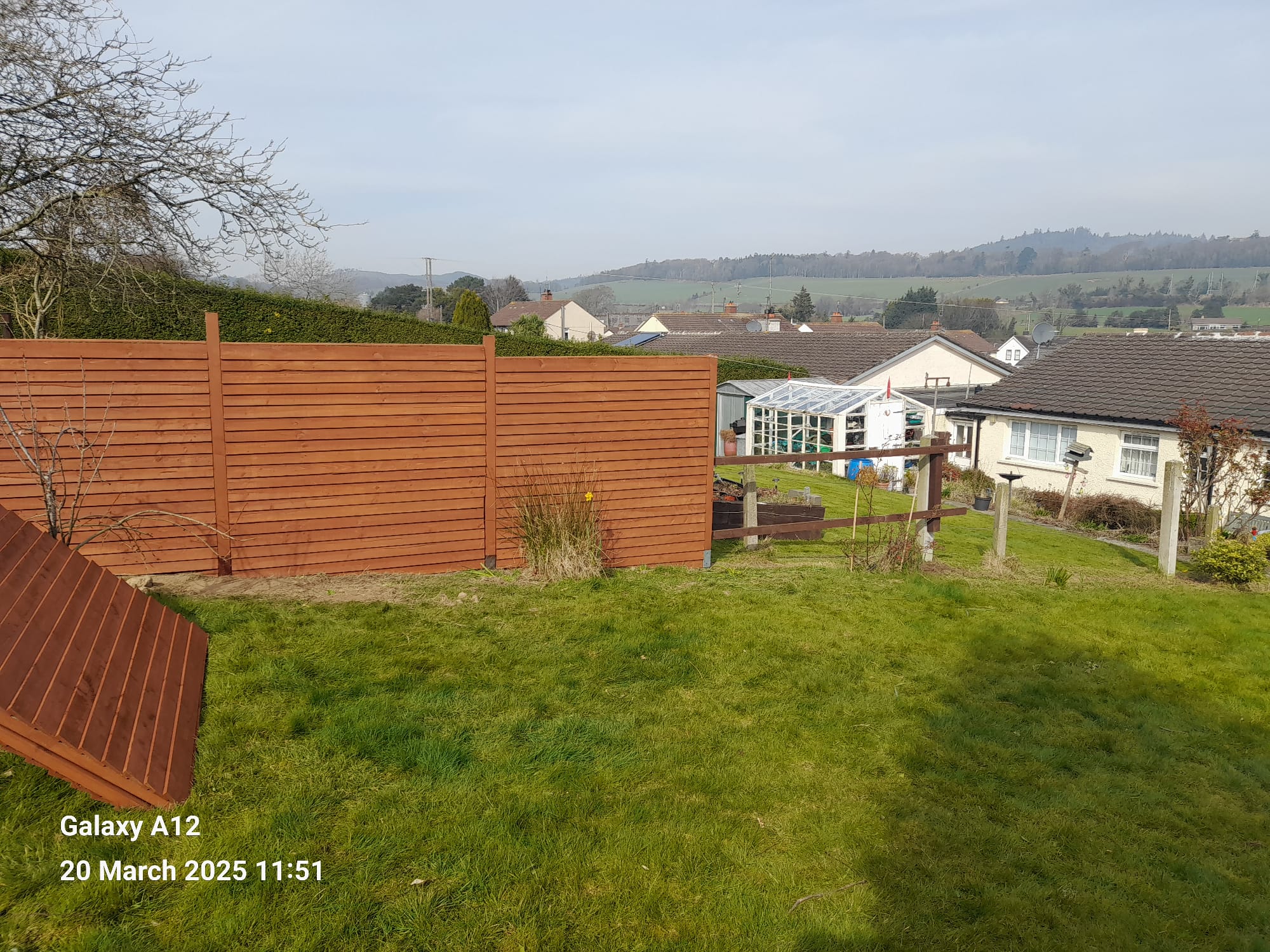 Fence panel awaiting installation, gaps between posts